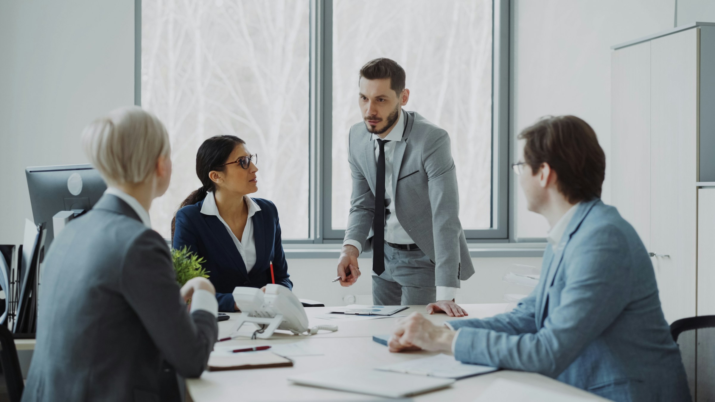 Business professionals discussing strategy in a meeting around a table