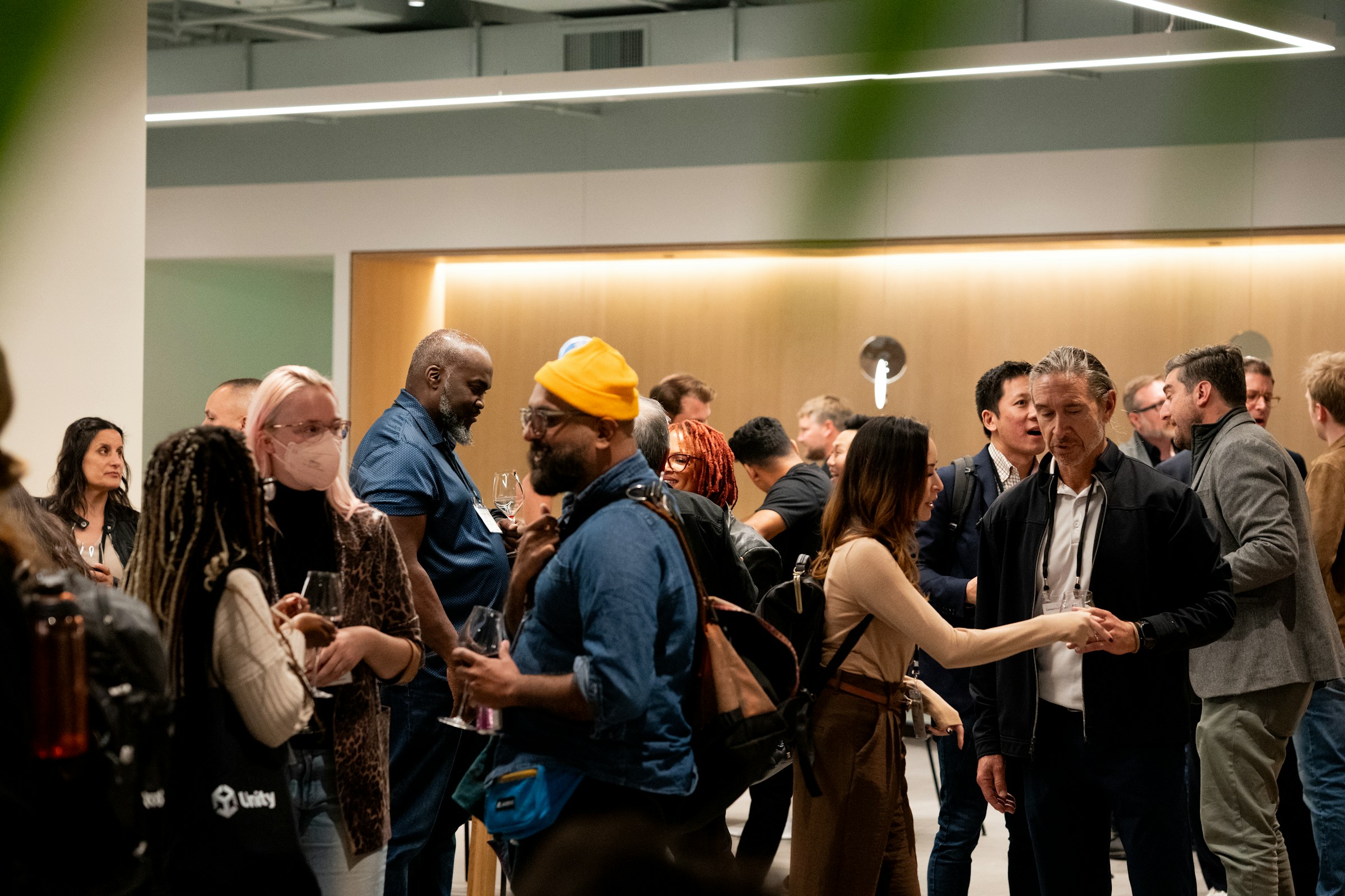 Guests networking with drinks at an indoor corporate hospitality event